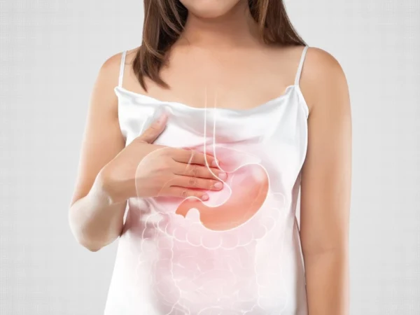 A woman in a white outfit suffering from gastroesophageal reflux