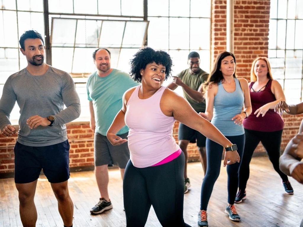 A group of people dancing at a gym