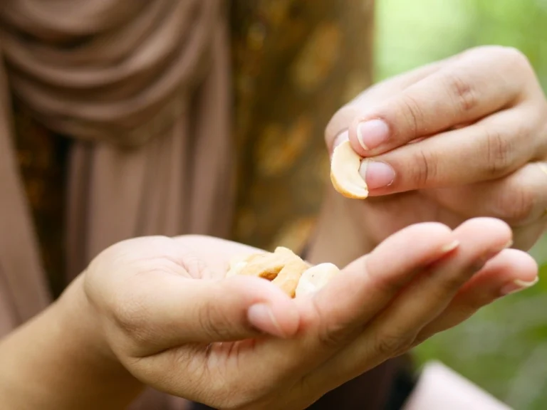 A woman eating cashew nuts