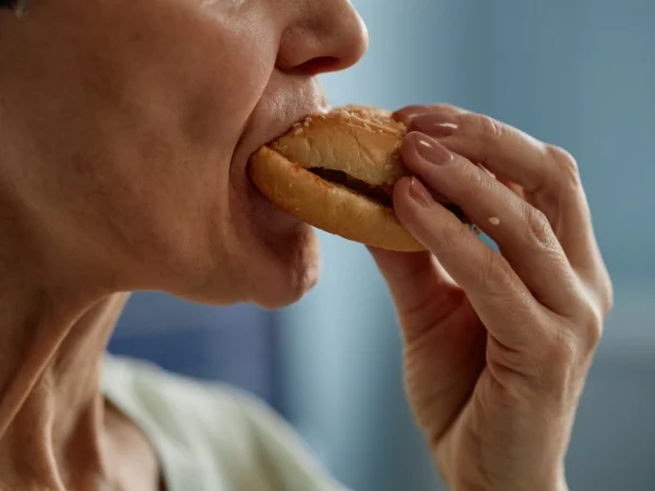 Woman biting into a burger