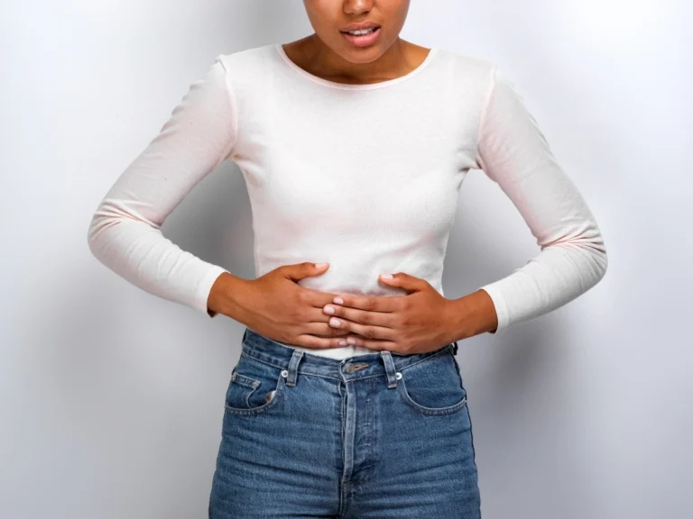 Woman holding her abdomen in pain