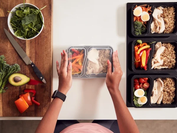 Woman preparing healthy meals for the week using food containers
