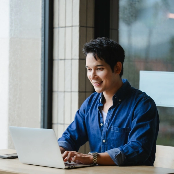 Young man working on laptop in modern office