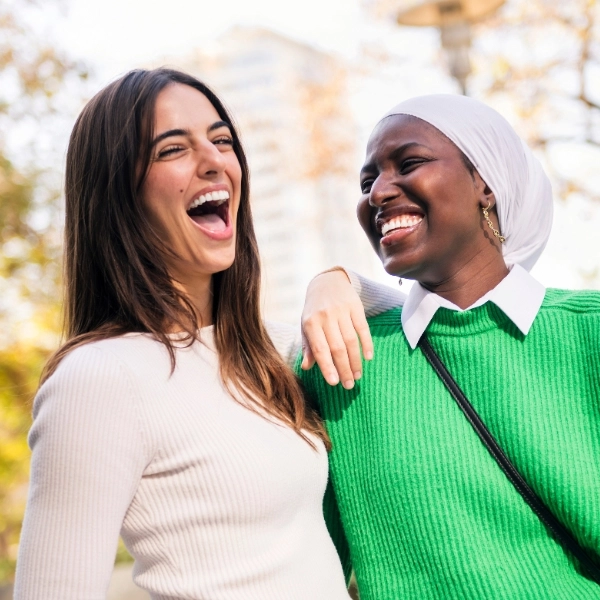 couple of two young women laughing and having fun