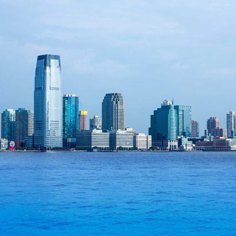 The view of the Jersey City, New Jersey skyline with skyscrapers visible across the Hudson River.
