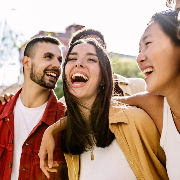 Diverse group of young friends having fun together outdoors in summer